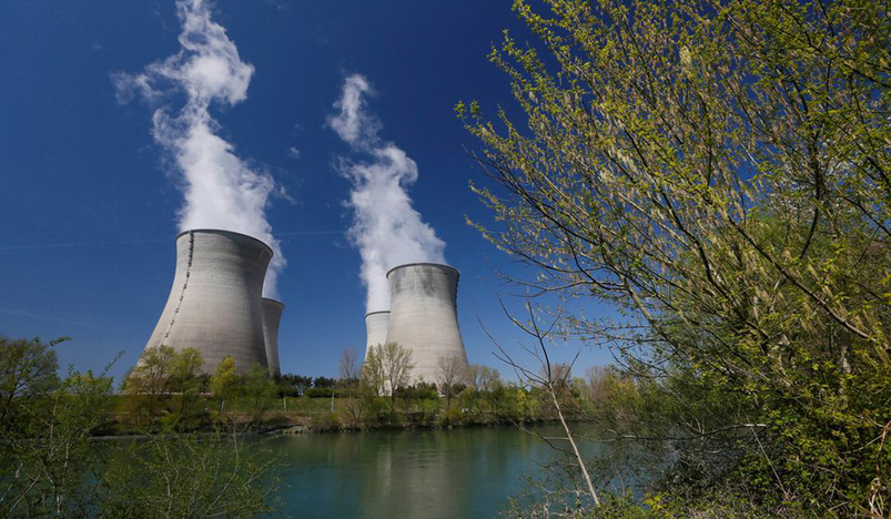 Steam rises from the cooling towers